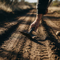 Hand smoothing a dirt road, reflecting preparation in Luke and Luke, symbolizing inner readiness for the Lord's path.