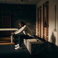 An athlete focused on a playbook in a rehab gym, symbolizing Luke's teaching on Christ found in Scripture.