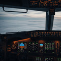 The view from a calm airplane cockpit with glowing instruments, flying through a thick and turbulent fog.