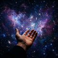 A human hand reaching out from the darkness against a backdrop of the star-filled cosmos.