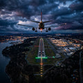 An airplane prepares to land on an illuminated runway at dusk, flying through turbulent clouds.