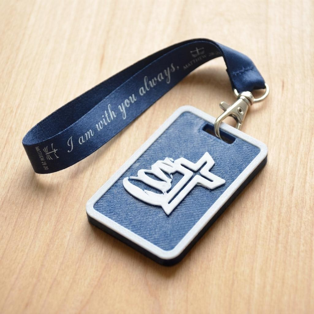A 3D-printed Eben Tag in Carbon Blue featuring a raised Galed stacked stone design. This NFC-enabled touchpoint is designed to trigger the Daily Eb devotional.