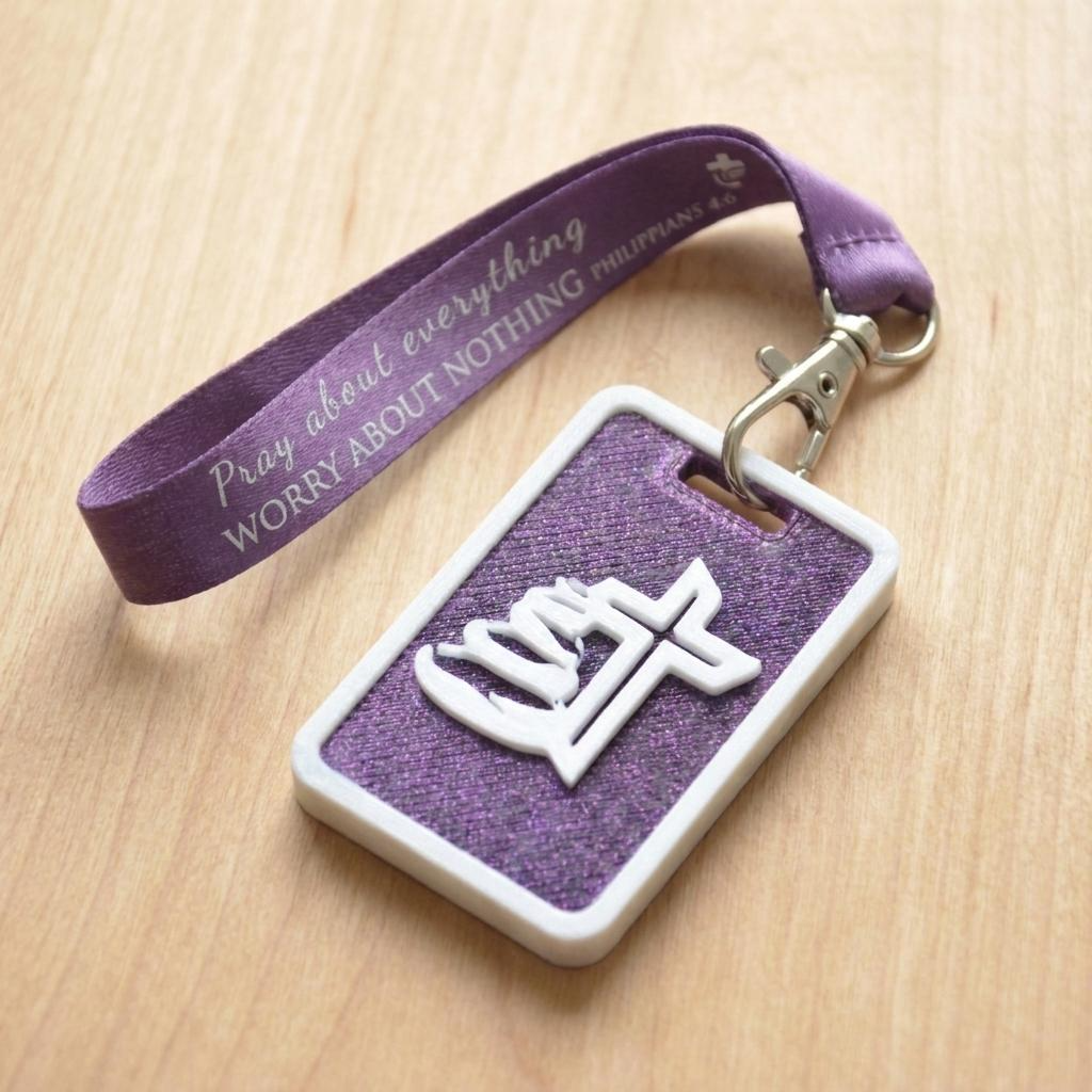 A 3D-printed Eben Tag in Metallic Purple featuring a raised Galed stacked stone design. This NFC-enabled touchpoint is designed to trigger the Daily Eb devotional.
