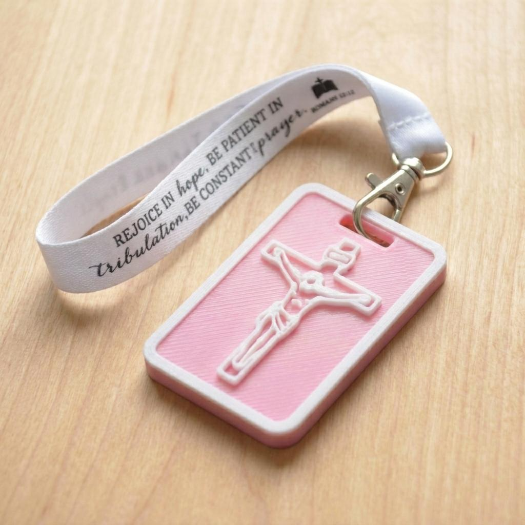A 3D-printed Eben Tag in White and Pink featuring a raised crucifix design. This NFC-enabled spiritual touchpoint includes a white border and is attached to a fabric lanyard printed with scripture, designed to trigger the Daily Eb devotional.