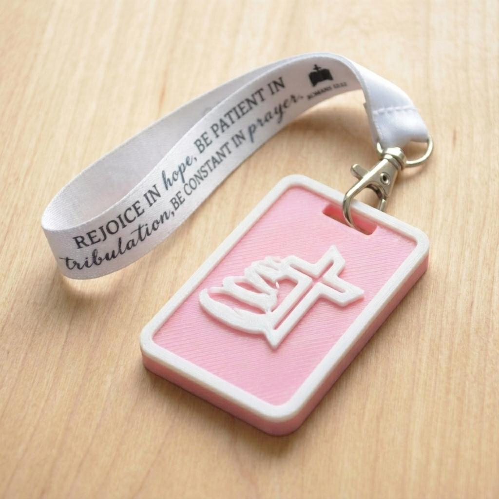 A 3D-printed Eben Tag in Pink featuring a raised Galed stacked stone design. This NFC-enabled touchpoint is designed to trigger the Daily Eb devotional.