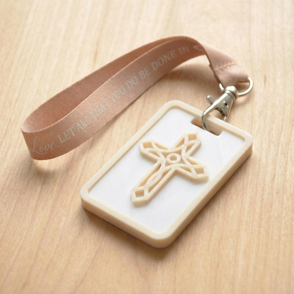 A 3D-printed Eben Tag in White and Beige featuring a raised ornate cross design. This NFC-enabled spiritual touchpoint includes a beige border and is attached to a fabric lanyard printed with scripture, designed to trigger the Daily Eb devotional.